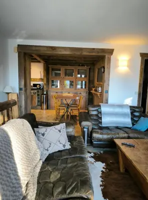 a living room with a couch and a table at Apartment in residence near the Mont d'Arbois in Megève