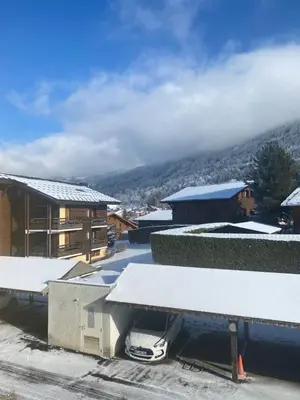 a building with snow on the roof of it at Les blanches aiguilles in Les Carroz d'Araches