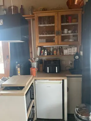 a kitchen with a refrigerator and a counter top at Les blanches aiguilles in Les Carroz d'Araches
