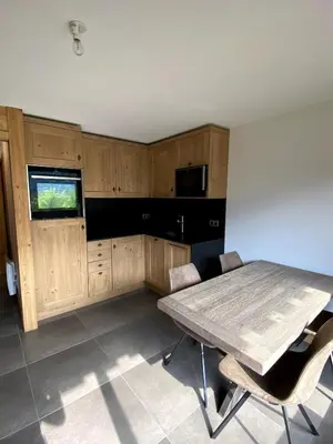 a kitchen with a table and chairs in a room at Le Nid Douillet des Gerets in Saint-Gervais-les-Bains