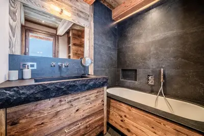 a bathroom with a bath tub and a sink at Chalet Betula, Saint-Gervais - by EMERALD STAY in Saint-Gervais-les-Bains