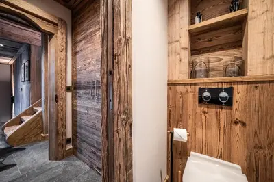 a bathroom with wood paneling and a wooden wall at Chalet Betula, Saint-Gervais - by EMERALD STAY in Saint-Gervais-les-Bains