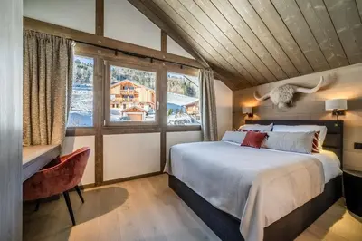 a bedroom with a large bed and a window at Chalet Luluvert, Saint-Gervais - by EMERALD STAY in Saint-Gervais-les-Bains