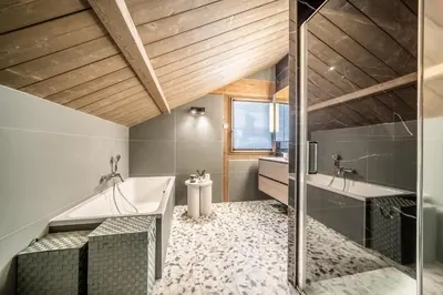 a bathroom with a tub and a shower and a sink at Chalet Luluvert, Saint-Gervais - by EMERALD STAY in Saint-Gervais-les-Bains