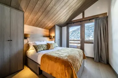 a bedroom with a bed and a large window at Chalet Luluvert, Saint-Gervais - by EMERALD STAY in Saint-Gervais-les-Bains