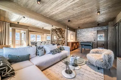 a living room with a white couch and a table at Chalet Luluvert, Saint-Gervais - by EMERALD STAY in Saint-Gervais-les-Bains