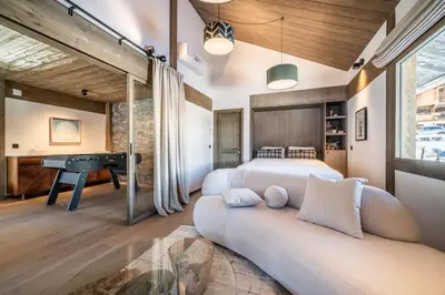a bedroom with a bed and a pool table at Chalet Luluvert, Saint-Gervais - by EMERALD STAY in Saint-Gervais-les-Bains