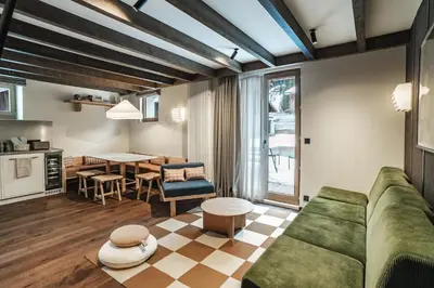 a living room with a couch and a table at Appartements de l'Héliopic in Chamonix-Mont-Blanc