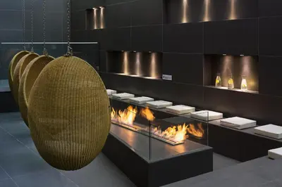a room with a fireplace and a hanging basket at Appartements de l'Héliopic in Chamonix-Mont-Blanc