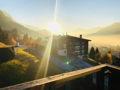 a house with the sun shining down on it at Superbe duplex with Hammam-Spa in Megève in Megève