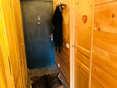 a hallway with a cat in a wooden room at Superbe duplex with Hammam-Spa in Megève in Megève