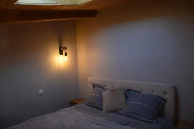 a bedroom with a bed with blue sheets and blue pillows at Superbe duplex with Hammam-Spa in Megève in Megève