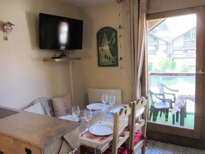 a dining room with a table with chairs and a television at Résidence Combettes - Combettes E288 MAE-5071 in Les Contamines-Montjoie