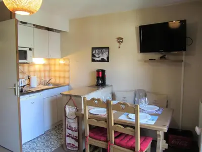 a small kitchen with a table and a television on the wall at Résidence Combettes - Combettes E288 MAE-5071 in Les Contamines-Montjoie