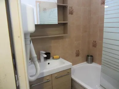 a bathroom with a white sink and a bath tub at Résidence Combettes - Combettes E288 MAE-5071 in Les Contamines-Montjoie