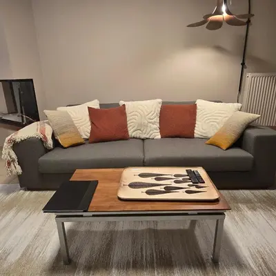 a living room with a couch and a coffee table at Le Miroir De Saint-Jacques in Sallanches