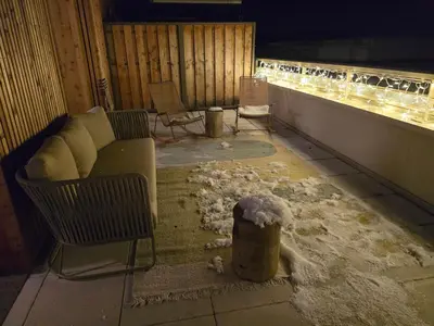 a room with a couch and chairs and snow on the floor at Le Miroir De Saint-Jacques in Sallanches