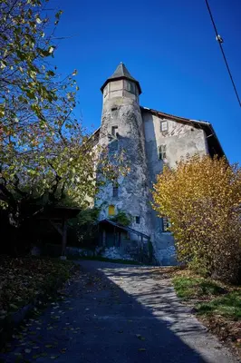 an old stone building with a tower on top of it at Le Miroir De Saint-Jacques in Sallanches