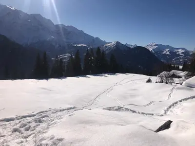 a snow covered slope with mountains in the background at Chez Sab in Passy