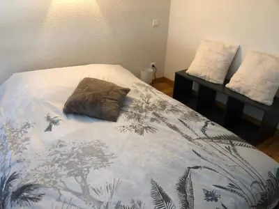 a bed with a pillow sitting on top of it at Chez Sab in Passy