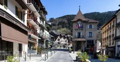 an empty street in a town with a clock tower at Chez Sab in Passy
