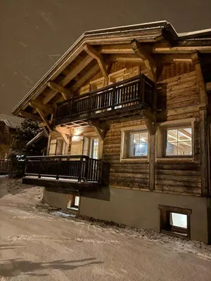 a wooden house with a balcony on the side of it at Chalet Nuances certifié 5 étoiles in Les Contamines-Montjoie