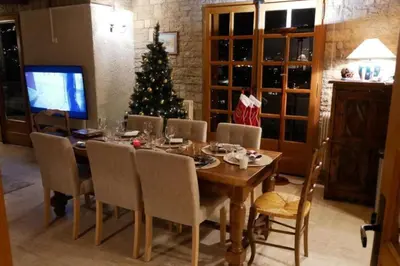 a dining room with a table and a christmas tree at Sumptuous chalet with breathtaking mountain views in Megève