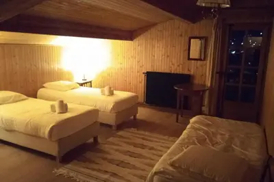 a hotel room with two beds and a television at Sumptuous chalet with breathtaking mountain views in Megève