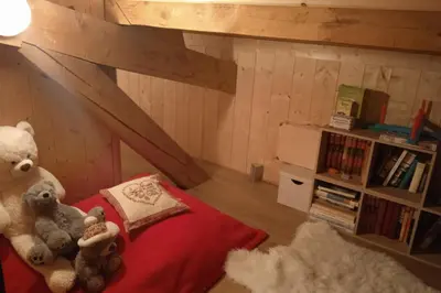 two stuffed teddy bears sitting on a bed in a room at Sumptuous chalet with breathtaking mountain views in Megève