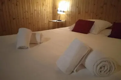 a hotel room with a white bed with towels on it at Sumptuous chalet with breathtaking mountain views in Megève