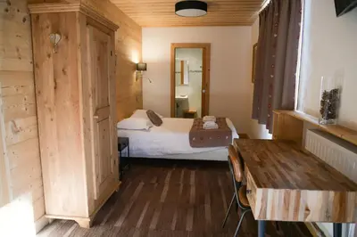 a bedroom with a bed and a table in a room at Le Dahu in Chamonix-Mont-Blanc