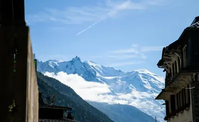 a view of a snow covered mountain in the distance at Le Dahu in Chamonix-Mont-Blanc