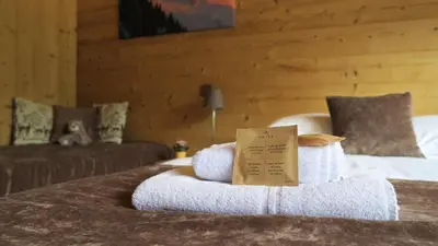 a pile of towels on top of a bed at Le Dahu in Chamonix-Mont-Blanc