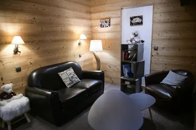 a living room with two leather chairs and a table at Le Dahu in Chamonix-Mont-Blanc