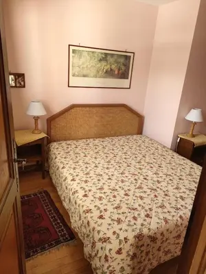 a bedroom with a bed and a painting on the wall at LE CLOS DE RENNEs in Megève