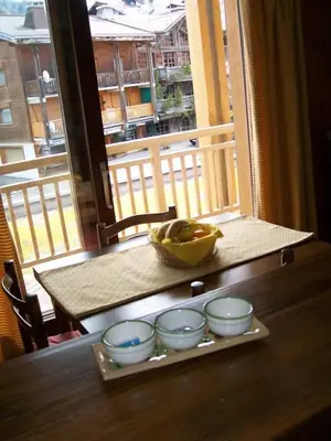 a table with bowls and a bowl of fruit on it at LE CLOS DE RENNEs in Megève