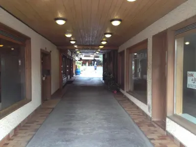an empty hallway of a building with lights on the ceiling at LE CLOS DE RENNEs in Megève