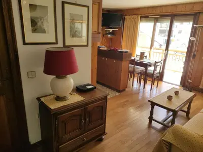 a living room with a lamp on top of a table at LE CLOS DE RENNEs in Megève