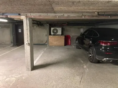 a parking garage with a car parked in it at LE CLOS DE RENNEs in Megève