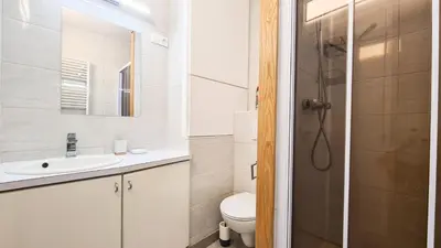a bathroom with a toilet and a sink and a shower at Résidence Capricorne - Appartement entièrement rénové · Au pied des pistes · Balcon MAE-4974 in Magland