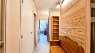 a hallway with a wooden wall in a house at Résidence Capricorne - Appartement entièrement rénové · Au pied des pistes · Balcon MAE-4974 in Magland