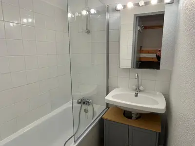 a white bathroom with a sink and a shower at Studio 19m² à Samoëns, 4 pers, animaux admis, parking - FR-1-629-144 in Samoëns