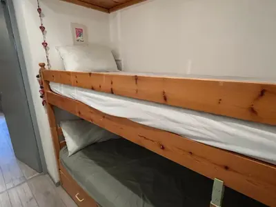 a purple bed in a room with a window at Studio 19m² à Samoëns, 4 pers, animaux admis, parking - FR-1-629-144 in Samoëns