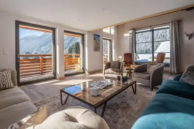 a living room with a couch and a table at Chalet Les Grands Montets in Chamonix-Mont-Blanc