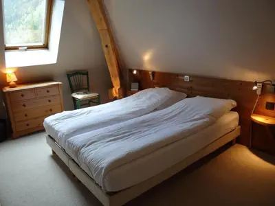 a bedroom with a large bed and a window at Les Terrasses des Glaciers - Appartement 2 in Chamonix-Mont-Blanc