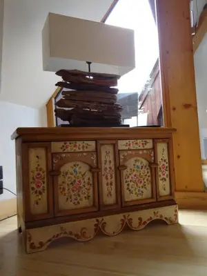 a wooden cabinet with a lamp on top of it at Les Terrasses des Glaciers - Appartement 2 in Chamonix-Mont-Blanc