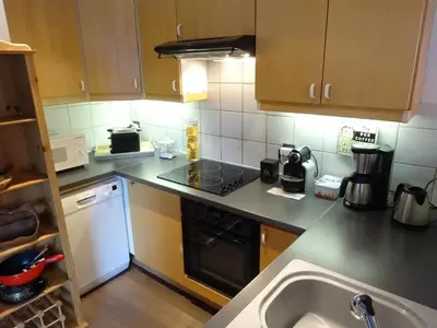 a kitchen with a sink and a stove top oven at Les Terrasses des Glaciers - Appartement 2 in Chamonix-Mont-Blanc