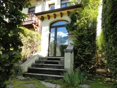 a house with stairs leading up to a door at Les Terrasses des Glaciers - Appartement 2 in Chamonix-Mont-Blanc