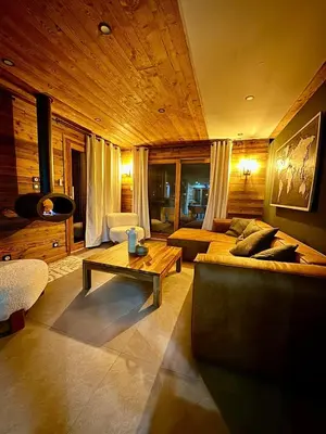 a living room with a couch and a coffee table at Chalet Monarch - Les Carroz - Sauna, Spa & vue Montagnes in Arâches-la-Frasse