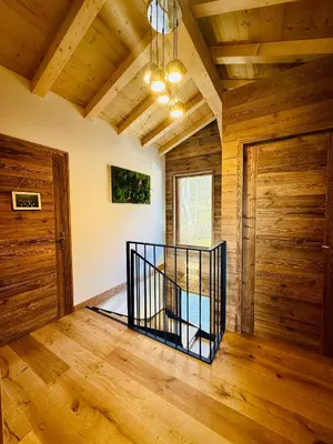 a room with a staircase and wooden walls and wooden floors at Chalet Monarch - Les Carroz - Sauna, Spa & vue Montagnes in Arâches-la-Frasse